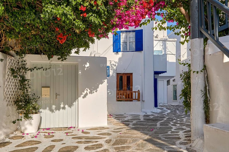 Romantic traditional narrow streets and beautiful walkways of Greek island towns. Whitewashed houses