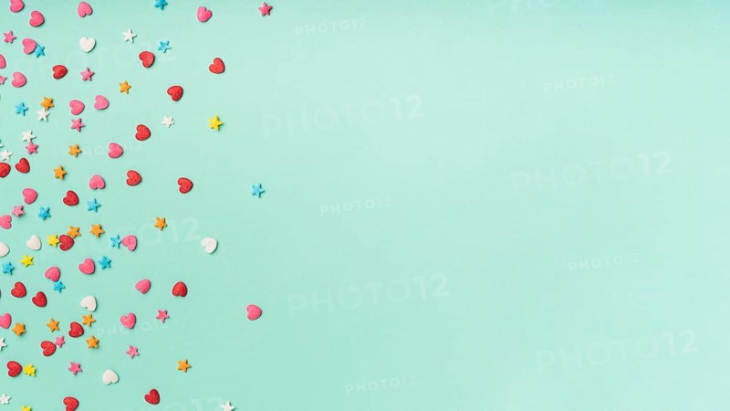 Stars hearts confetti turquoise background with copy space