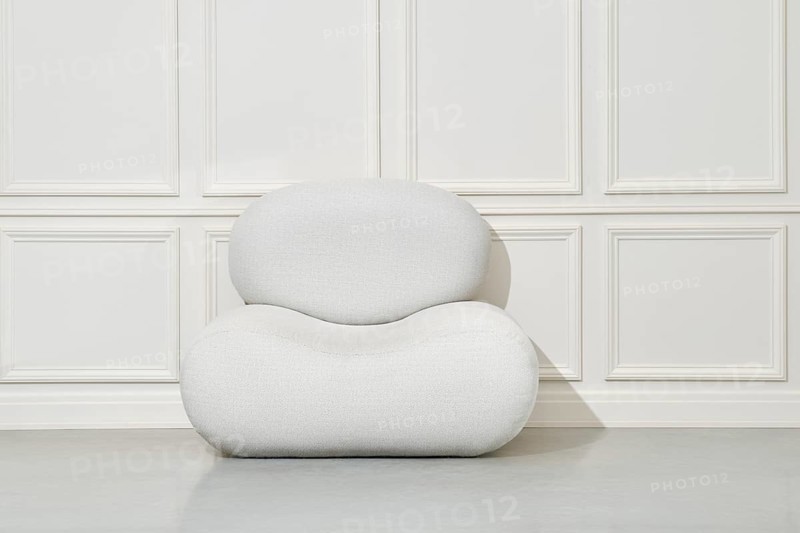 Large soft pouf or beanbag chair in bright room