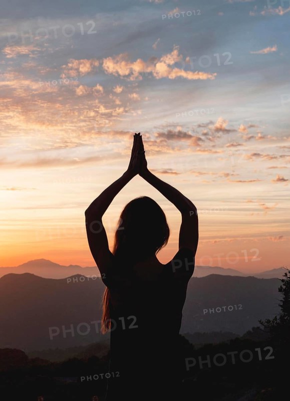 Back view woman yoga pose during sunset