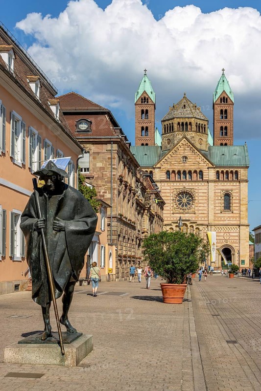 Bronze sculpture Jacob's Pilgrim by Martin Mayer and behind it The Imperial Cathedral of Speyer also called Speyer Cathedral or Cathedral Church of St Mary and St Stephen