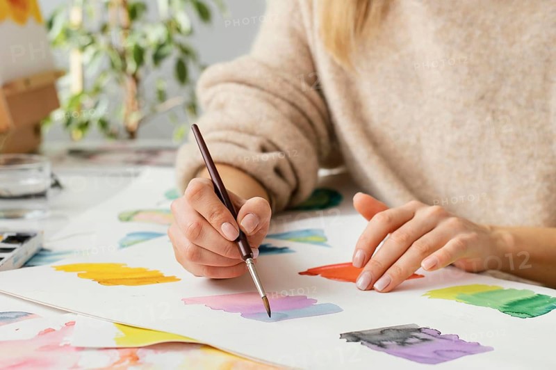 Young woman painting with watercolors