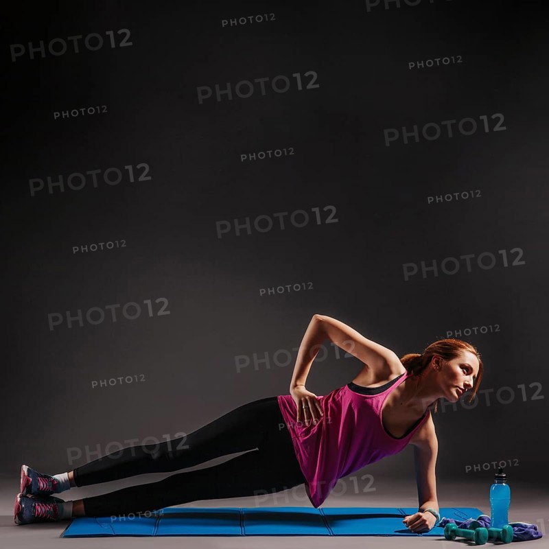 Young woman doing side plank