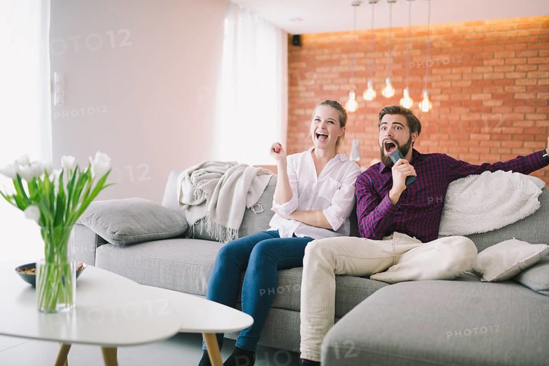 Emotional couple watching tv