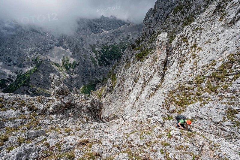 Mountaineer climbing in steep rocky terrain on the way to Waxenstein