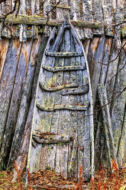 Old Sami sled by a shed with lichens