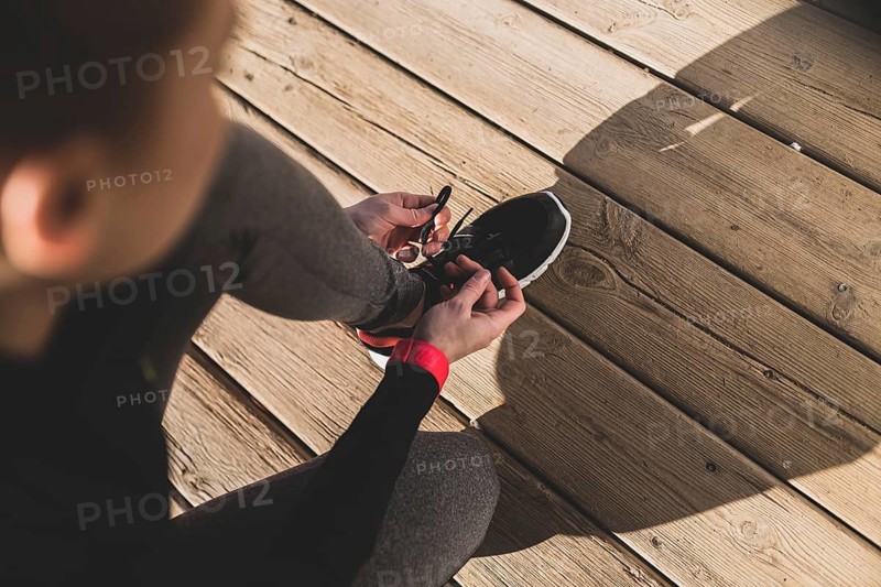 Woman preparing her sneakers before starting run