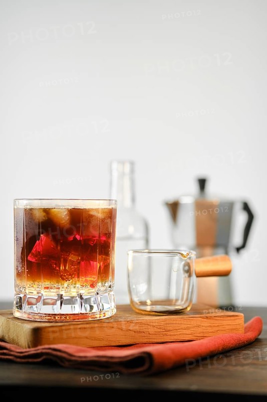 Hot espresso coffee in glass with cold tonic and ice