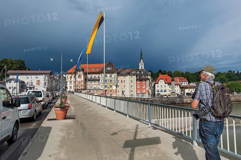 Flag-decorated bridge over the Isar with Gewiierhimmel