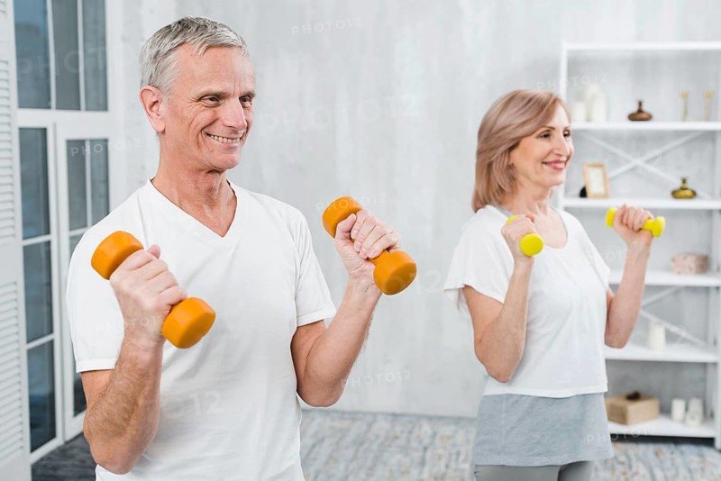 Joyful couple exercising home