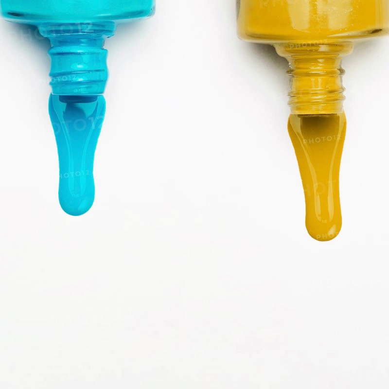 Top view spilled nail polish white backdrop