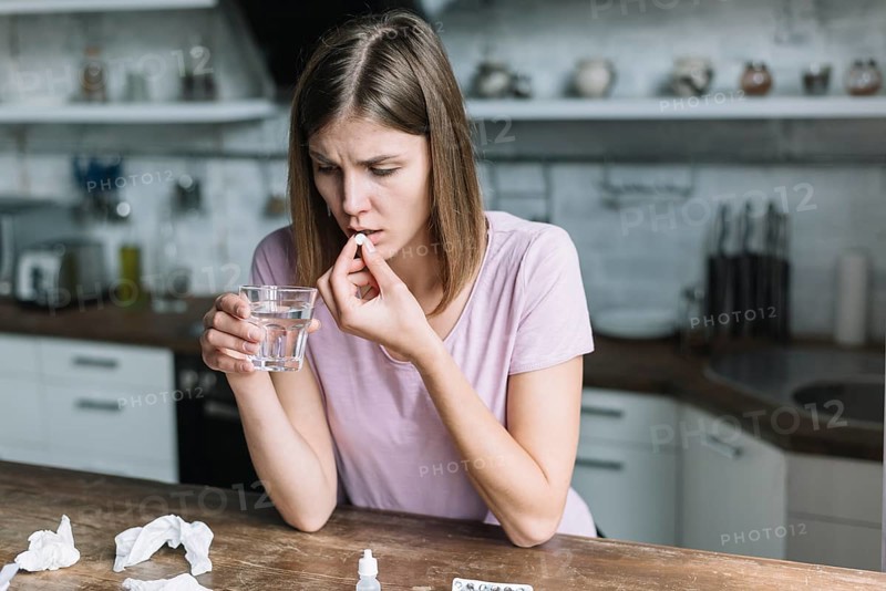 Woman having fever taking medicine home