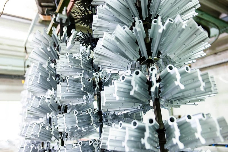 Profiles hanging from a dipping device in a galvanising plant