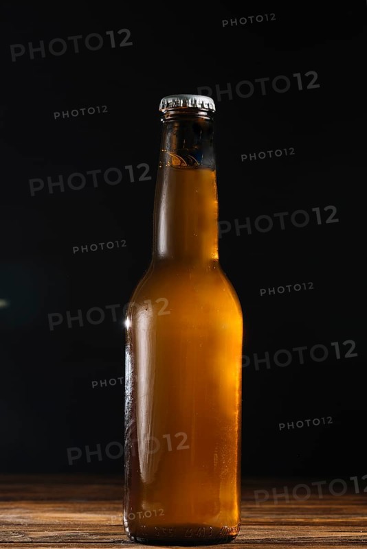 Close up beer bottle wooden desk