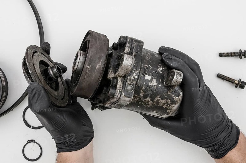 Man disassembling mechanical part cleaning