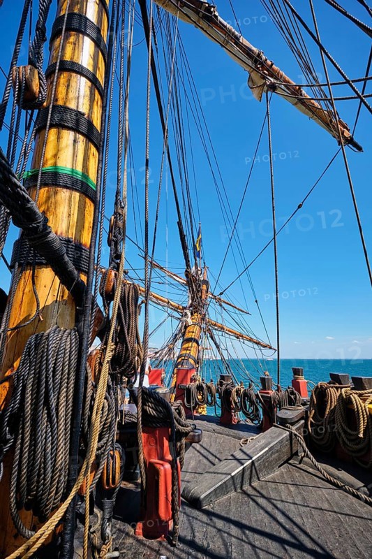 Deck with mast and ropes and bowspirit of wooden Age of sail sailing ship