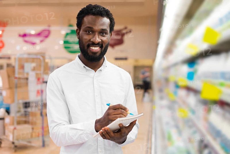 Man checking off items shopping list