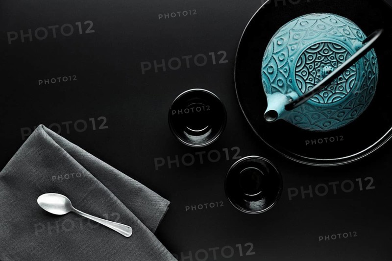 Flat lay crockery with teapot silver spoon