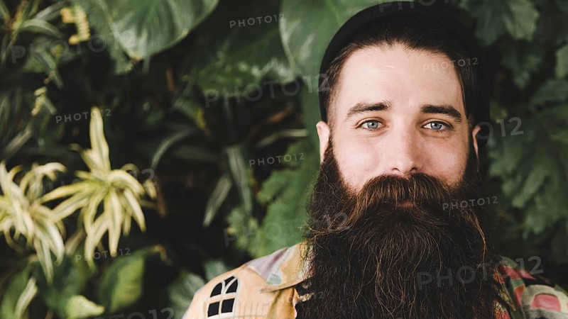 Panoramic view bearded young man looking camera
