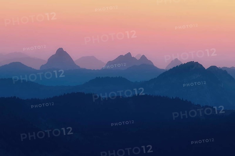 Hilly landscape with mountains Kleiner and Grosser Mythen after sunset