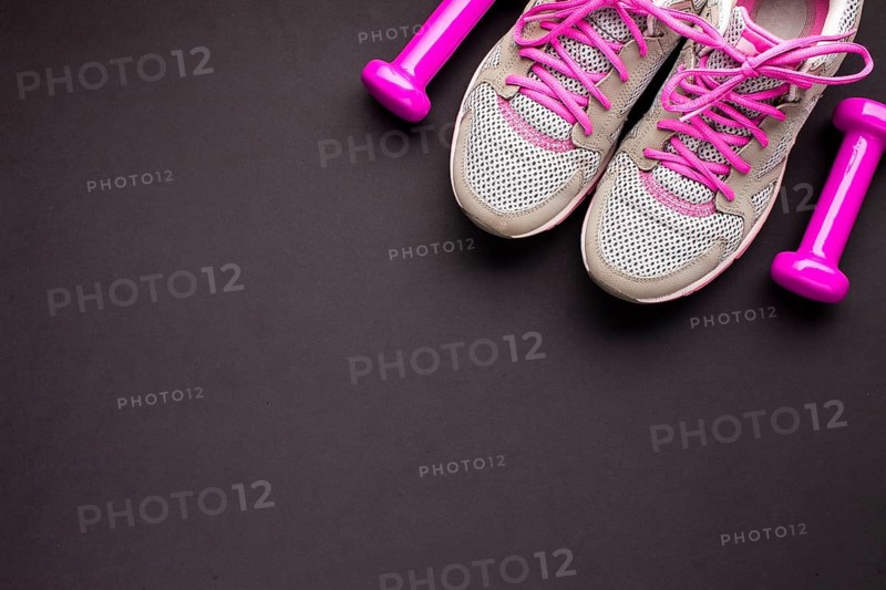 Top view arrangement with pink shoes dumbbells