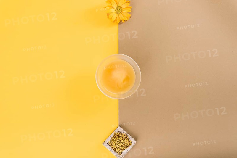 Elevated view flowers lemon curd bee pollen dual colored background