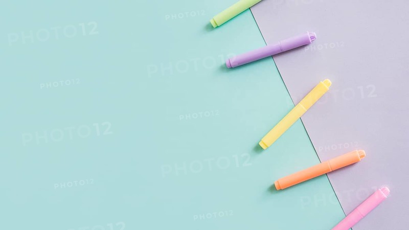 Multi colored markers grey green paper background