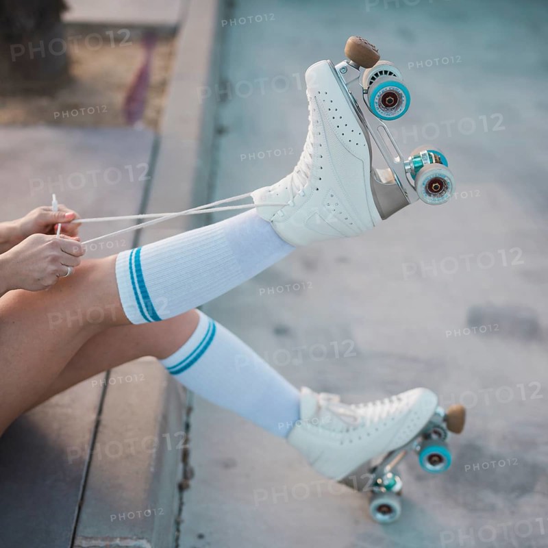 Low section woman tying lace roller skate road