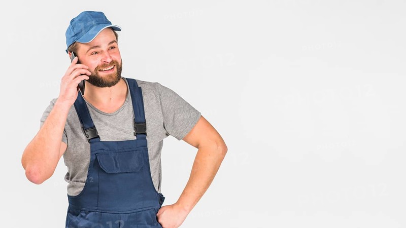 Man overall talking by phone