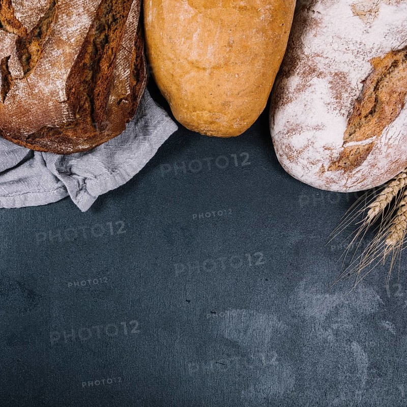 Overhead view rustic loaf breads black counter top