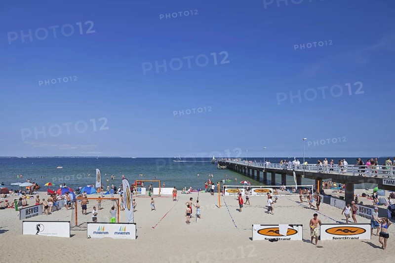 Tourists playing beach volleyball and soccer at Timmendorfer Strand