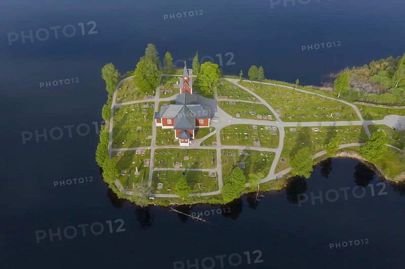 Aerial view over the red wooden Raemmens kyrka