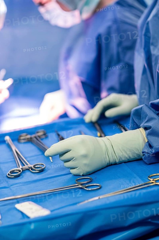 Operating table with surgical cutlery during an operation in a hospital