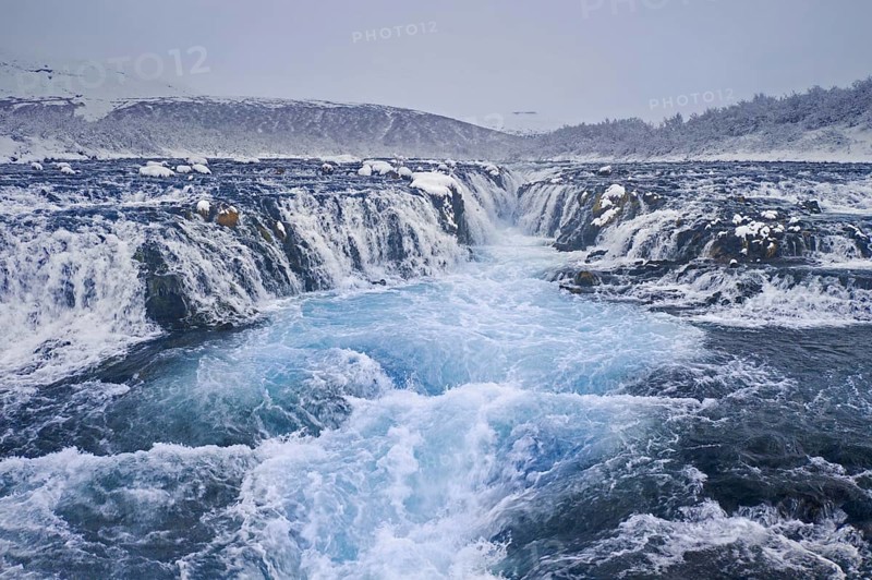 Aerial view over Bruarfoss waterfall in winter