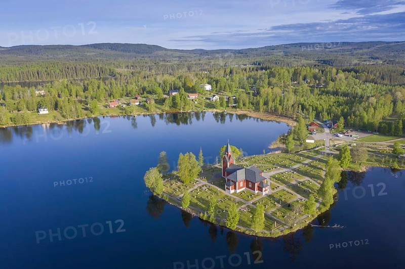 Aerial view over the red wooden Raemmens kyrka