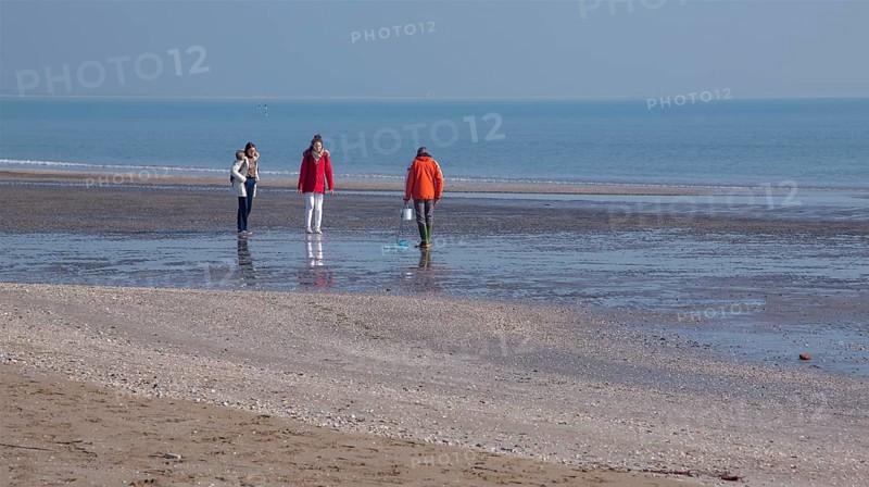 Beach walkers in winter at Lido di Venezia