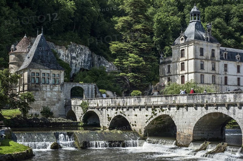 The Benedictine abbey abbaye Saint-Pierre de Brantome and bridge over the river Dronne