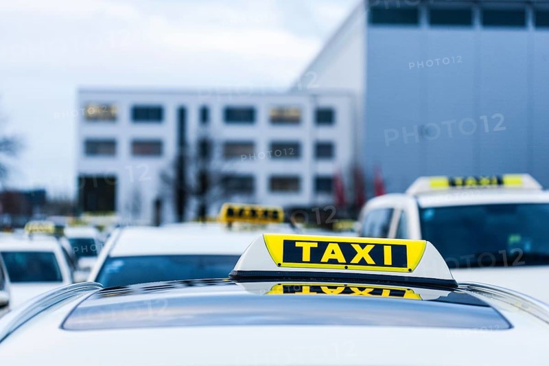 Many taxis stand and wait at a holding area at Duesseldorf airport