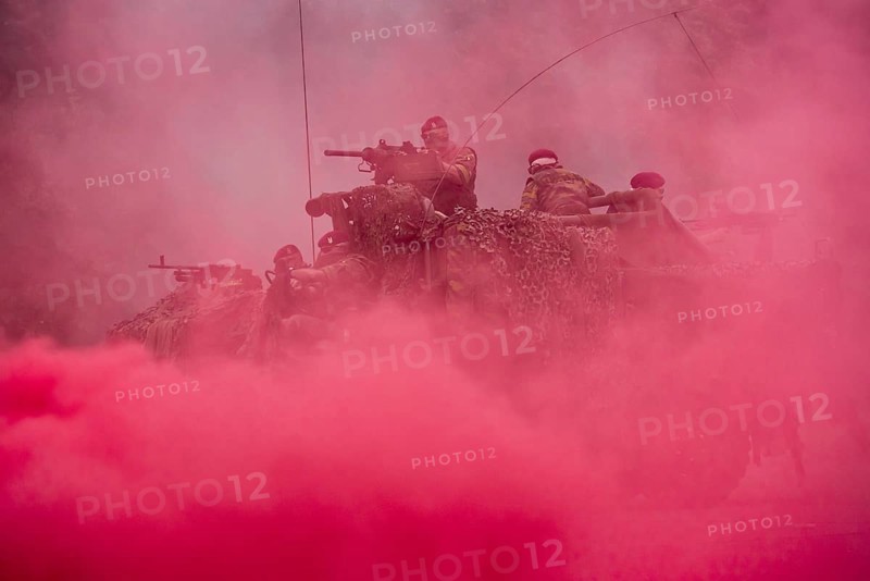 Red smoke curtain and commandos of the Para-Commando Regiment under attack in LRPV armoured vehicle firing mounted machine guns