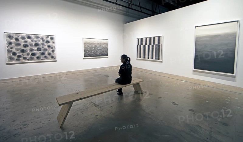 Korean woman looking at a Korean artwork