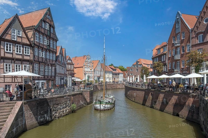 Historic merchant and warehouse houses at the Hanseatic harbour with the sailing ship Willi