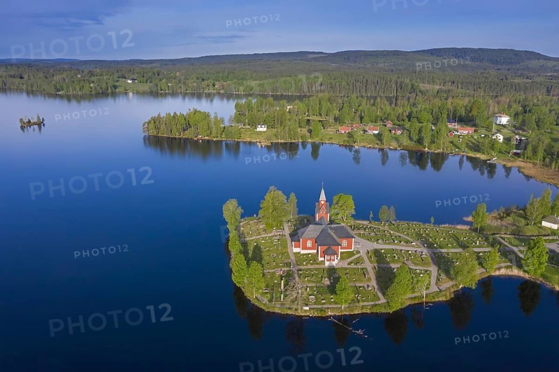 Aerial view over the red wooden Raemmens kyrka