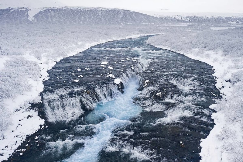 Aerial view over Bruarfoss waterfall in winter