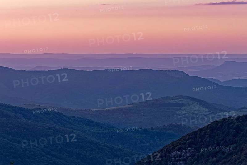 Evening mood over the mountain landscape of the Balkan Mountains and the forested slopes of the Balgarka nature park Park in Central Bulgaria. Shipka