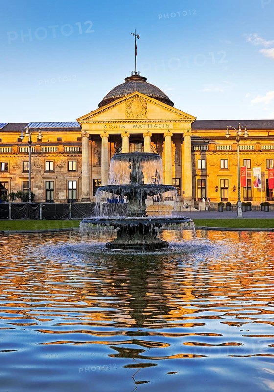 Spa hotel and Casino in late evening light with cascade fountain