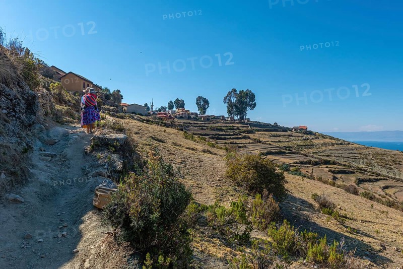 Local woman carrying child on her back