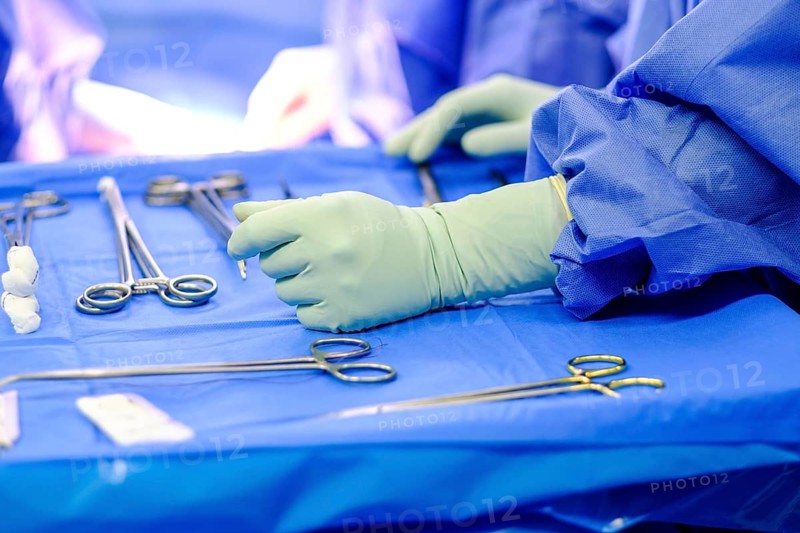 Operating table with surgical cutlery during an operation in a hospital