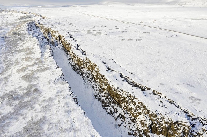 Aerial view over the Almannagja Canyon in the snow in winter