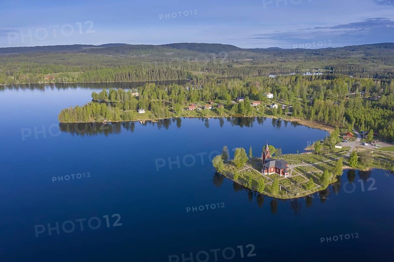 Aerial view over the red wooden Raemmens kyrka