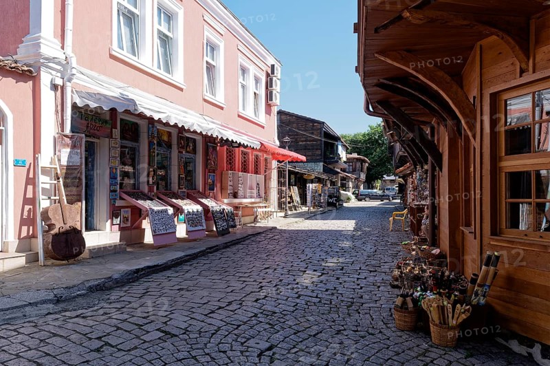 Half-timbered houses with wooden tops and roof overhangs typical of the locality on the cobbled street in the old town. Sozopol